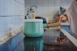 Pot and vegetables in modern kitchen