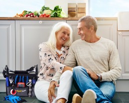 Couple sitting on floor with tools