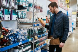 Young handyman or DIY homeowner in a store